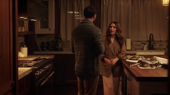 Movie still from “Deborah” (2022), directed by Noga Pnueli – A man and a woman are standing in a kitchen; Medium shot, Over the shoulder angle