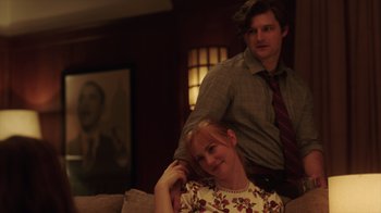 Movie still from “Deborah” (2022), directed by Noga Pnueli – A man and a woman sitting on top of a couch; Medium shot, Low angle