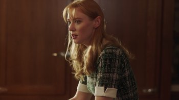 Movie still from “Deborah” (2022), directed by Noga Pnueli – A woman with blonde hair wearing a green and white dress; Medium shot, Over the shoulder angle