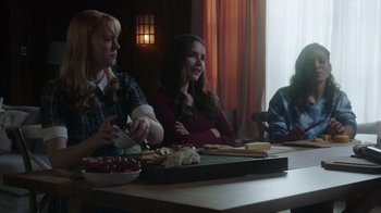 Movie still from “Deborah” (2022), directed by Noga Pnueli – A group of people sitting at a table with food; Medium shot, Over the shoulder angle