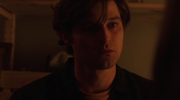 Movie still from “Deborah” (2022), directed by Noga Pnueli – A person wearing a black shirt; Close Up shot, Low angle