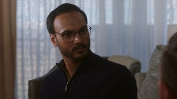 Movie still from “Deborah” (2022), directed by Noga Pnueli – A person wearing glasses and a sweater; Close Up shot, Over the shoulder angle