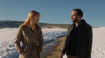 Movie still from “Deborah” (2022), directed by Noga Pnueli – A man and a woman standing next to each other on the beach; Medium shot, Over the shoulder angle