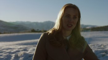 Movie still from “Deborah” (2022), directed by Noga Pnueli – A woman standing in the middle of a snowy field; Close Up shot, Over the shoulder angle