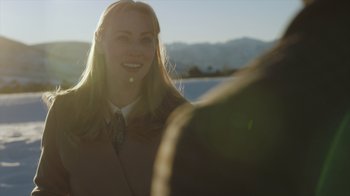 Movie still from “Deborah” (2022), directed by Noga Pnueli – A woman smiles at the camera while a man looks at her; Close Up shot, Over the shoulder angle