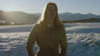 Movie still from “Deborah” (2022), directed by Noga Pnueli – A woman standing in the middle of a snow covered field; Medium shot, Low angle
