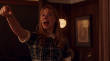 Movie still from “Deborah” (2022), directed by Noga Pnueli – A woman in a green and white dress holding her hand out; Medium shot, Low angle