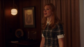 Movie still from “Deborah” (2022), directed by Noga Pnueli – A woman standing in front of a painting in a living room; Medium shot, Over the shoulder angle