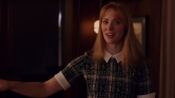 Movie still from “Deborah” (2022), directed by Noga Pnueli – A woman with blonde hair wearing a black and white shirt; Medium shot, Over the shoulder angle