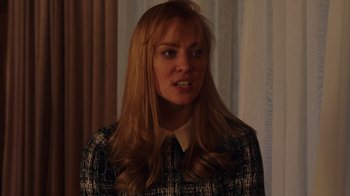 Movie still from “Deborah” (2022), directed by Noga Pnueli – A woman with long blonde hair wearing a black and white shirt; Close Up shot, Over the shoulder angle