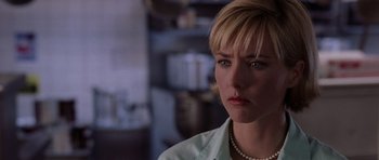 Movie still from “Deep Impact” (1998), directed by Mimi Leder – A person wearing a white shirt and pearls; Close Up shot, Over the shoulder angle