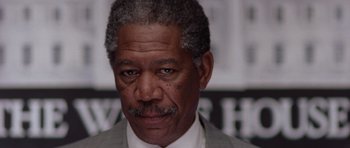 Movie still from “Deep Impact” (1998), directed by Mimi Leder – An older man in a gray suit and white shirt; Close Up shot, Low angle