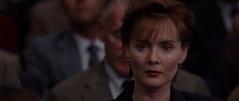 Movie still from “Deep Impact” (1998), directed by Mimi Leder – A person wearing a suit and tie; Close Up shot, Over the shoulder angle