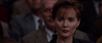 Movie still from “Deep Impact” (1998), directed by Mimi Leder – A person wearing a suit and tie; Close Up shot, Over the shoulder angle