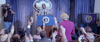 Movie still from “Deep Impact” (1998), directed by Mimi Leder – A man is giving a speech at the white house; Medium shot, Over the shoulder angle