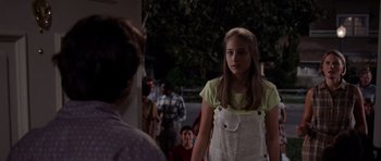 Movie still from “Deep Impact” (1998), directed by Mimi Leder – A young girl standing in front of an older woman; Medium shot, Over the shoulder angle