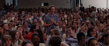 Movie still from “Deep Impact” (1998), directed by Mimi Leder – A man standing in front of a crowd of people; Medium shot, Over the shoulder angle