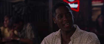 Movie still from “Deep Impact” (1998), directed by Mimi Leder – A person sitting at a table; Close Up shot, Over the shoulder angle