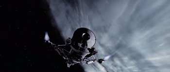 Movie still from “Deep Impact” (1998), directed by Mimi Leder – An image of a space ship in the dark sky; Extreme Wide shot, Overhead angle