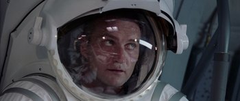 Movie still from “Deep Impact” (1998), directed by Mimi Leder – A man in a space suit looking into the reflection of a mirror; Close Up shot, Low angle