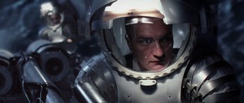 Movie still from “Deep Impact” (1998), directed by Mimi Leder – A man in a space suit looking into a mirror; Close Up shot, Overhead angle