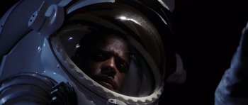 Movie still from “Deep Impact” (1998), directed by Mimi Leder – A person wearing a space helmet; Close Up shot, Overhead angle