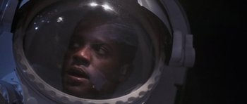 Movie still from “Deep Impact” (1998), directed by Mimi Leder – A man wearing a space helmet looking into the distance; Close Up shot, Low angle