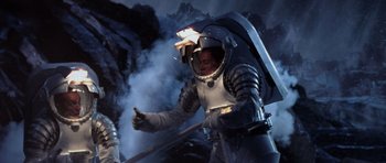 Movie still from “Deep Impact” (1998), directed by Mimi Leder – A man in a spacesuit is holding something in his hand; Medium shot, Low angle