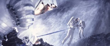 Movie still from “Deep Impact” (1998), directed by Mimi Leder – An image of a man on the moon with a sword in his hand; Wide shot, Overhead angle