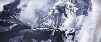 Movie still from “Deep Impact” (1998), directed by Mimi Leder – Two people in spacesuits are climbing a mountain; Wide shot, Overhead angle
