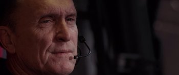 Movie still from “Deep Impact” (1998), directed by Mimi Leder – An older man wearing a headset with a microphone; Close Up shot, Low angle