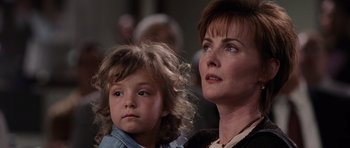 Movie still from “Deep Impact” (1998), directed by Mimi Leder – A woman and a child looking up at something in the air; Close Up shot, Over the shoulder angle