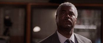 Movie still from “Deep Impact” (1998), directed by Mimi Leder – An older man in a suit and tie looking up; Close Up shot, Low angle