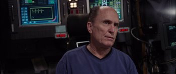 Movie still from “Deep Impact” (1998), directed by Mimi Leder – An older man sitting in front of a computer screen; Close Up shot, Low angle