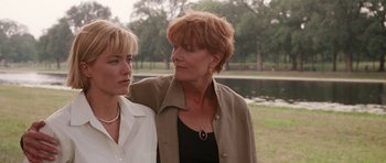 Movie still from “Deep Impact” (1998), directed by Mimi Leder – Two women standing next to each other near a body of water; Close Up shot, Over the shoulder angle