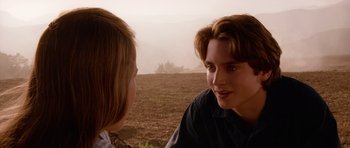 Movie still from “Deep Impact” (1998), directed by Mimi Leder – A young man and a young woman talking in a field; Close Up shot, Over the shoulder angle