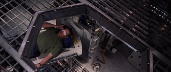 Movie still from “Deep Impact” (1998), directed by Mimi Leder – An overhead view of a man laying on a bed; Wide shot, Overhead angle