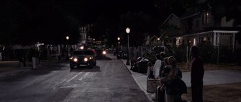 Movie still from “Deep Impact” (1998), directed by Mimi Leder – People are waiting to cross the street at night; Extreme Wide shot, High angle