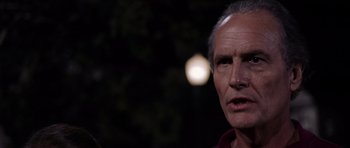 Movie still from “Deep Impact” (1998), directed by Mimi Leder – An older man is looking at the camera; Close Up shot, Over the shoulder angle