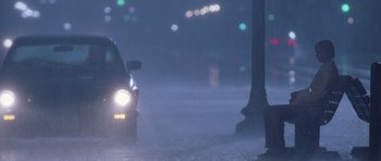 Movie still from “Deep Impact” (1998), directed by Mimi Leder – A car driving down a street in the rain; Extreme Wide shot, High angle