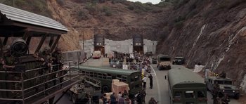 Movie still from “Deep Impact” (1998), directed by Mimi Leder – A group of people standing next to a bus; Extreme Wide shot, High angle