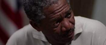 Movie still from “Deep Impact” (1998), directed by Mimi Leder – An older man with grey hair looking down at the ground; Close Up shot, Over the shoulder angle