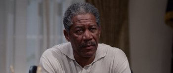 Movie still from “Deep Impact” (1998), directed by Mimi Leder – An older black man with a beard and mustache looking at the camera; Close Up shot, Over the shoulder angle