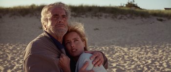 Movie still from “Deep Impact” (1998), directed by Mimi Leder – An older man and a younger woman on the beach; Close Up shot, Low angle