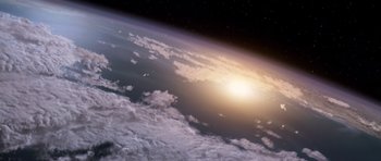 Movie still from “Deep Impact” (1998), directed by Mimi Leder – A view of the earth from space with the sun setting; Extreme Wide shot, Overhead angle