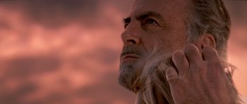 Movie still from “Deep Impact” (1998), directed by Mimi Leder – An old man with long hair and a long gray beard; Close Up shot, Over the shoulder angle