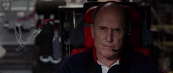 Movie still from “Deep Impact” (1998), directed by Mimi Leder – An older man with a microphone in his mouth; Close Up shot, Low angle