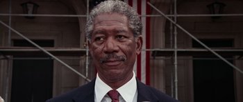 Movie still from “Deep Impact” (1998), directed by Mimi Leder – An older man in a suit and tie; Close Up shot, Low angle