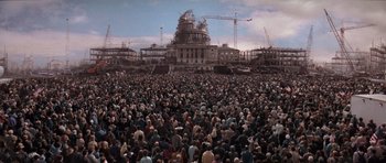 Movie still from “Deep Impact” (1998), directed by Mimi Leder – A large crowd of people gathered in front of a building; Extreme Wide shot, High angle