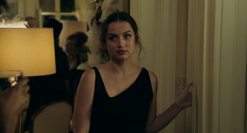 Movie still from “Deep Water” (2022), directed by Adrian Lyne – A woman in a black dress standing in front of a mirror; Close Up shot, Over the shoulder angle
